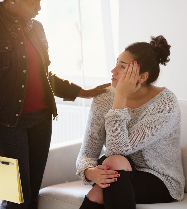 Woman being comforted by a counselor